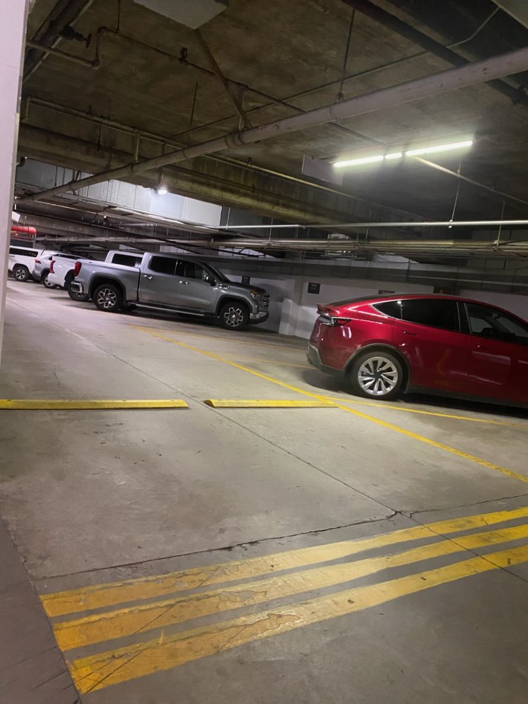 Cars parked in a dimly lit concrete parking garage