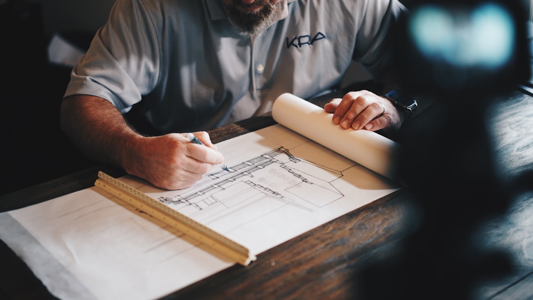 Architect reviewing technical drawings during engineering coordination