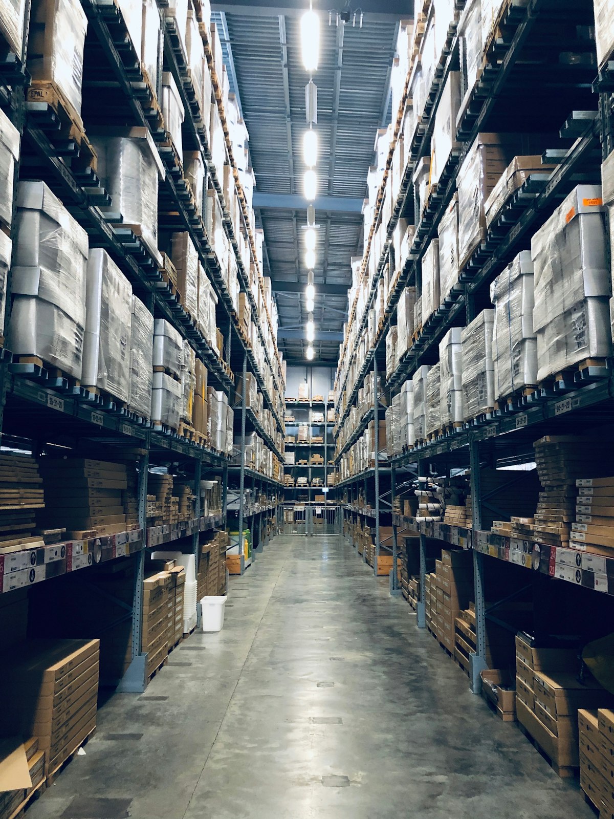 Empty warehouse with high ceilings showing exposed steel roof structure