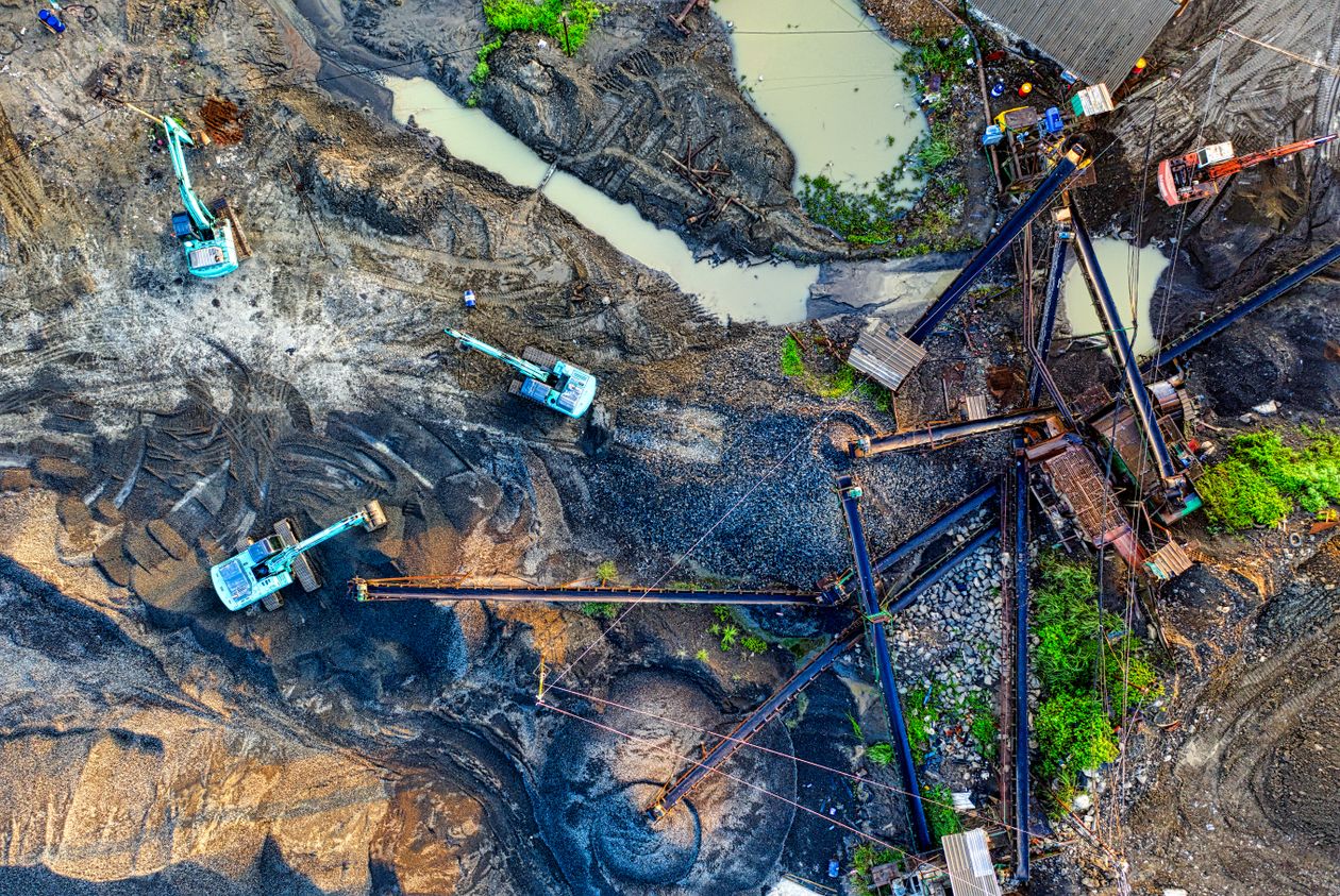 Aerial view of a construction site with heavy earthmoving equipment during grading operations