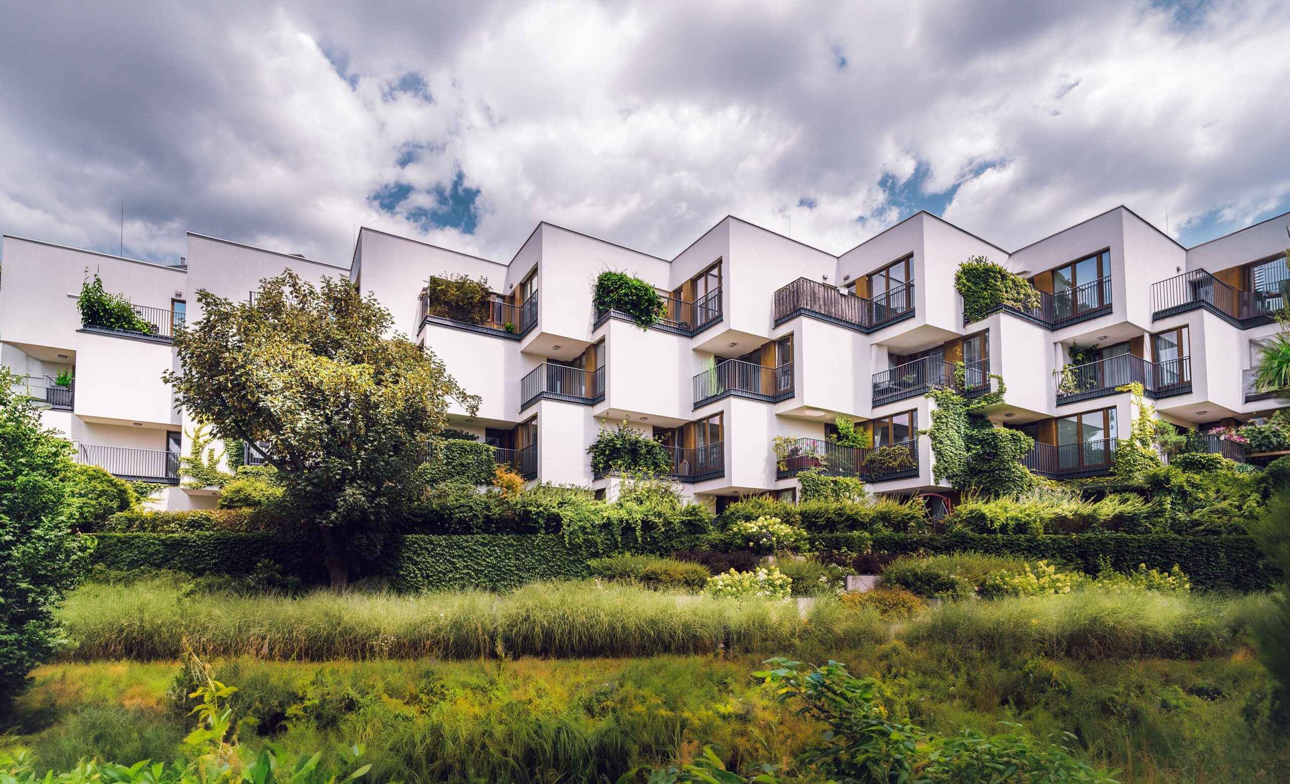 Contemporary sustainable apartment complex with balcony greenery